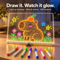 LED drawing board glowing with neon drawing and 7 pens
